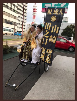 九州で人力車に乗った成人式のカップル